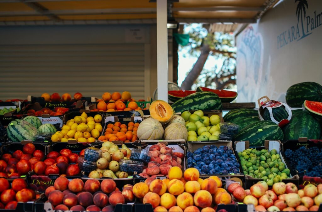 Home Vibrant variety of fresh fruits at an outdoor stand, perfect for a healthy diet.